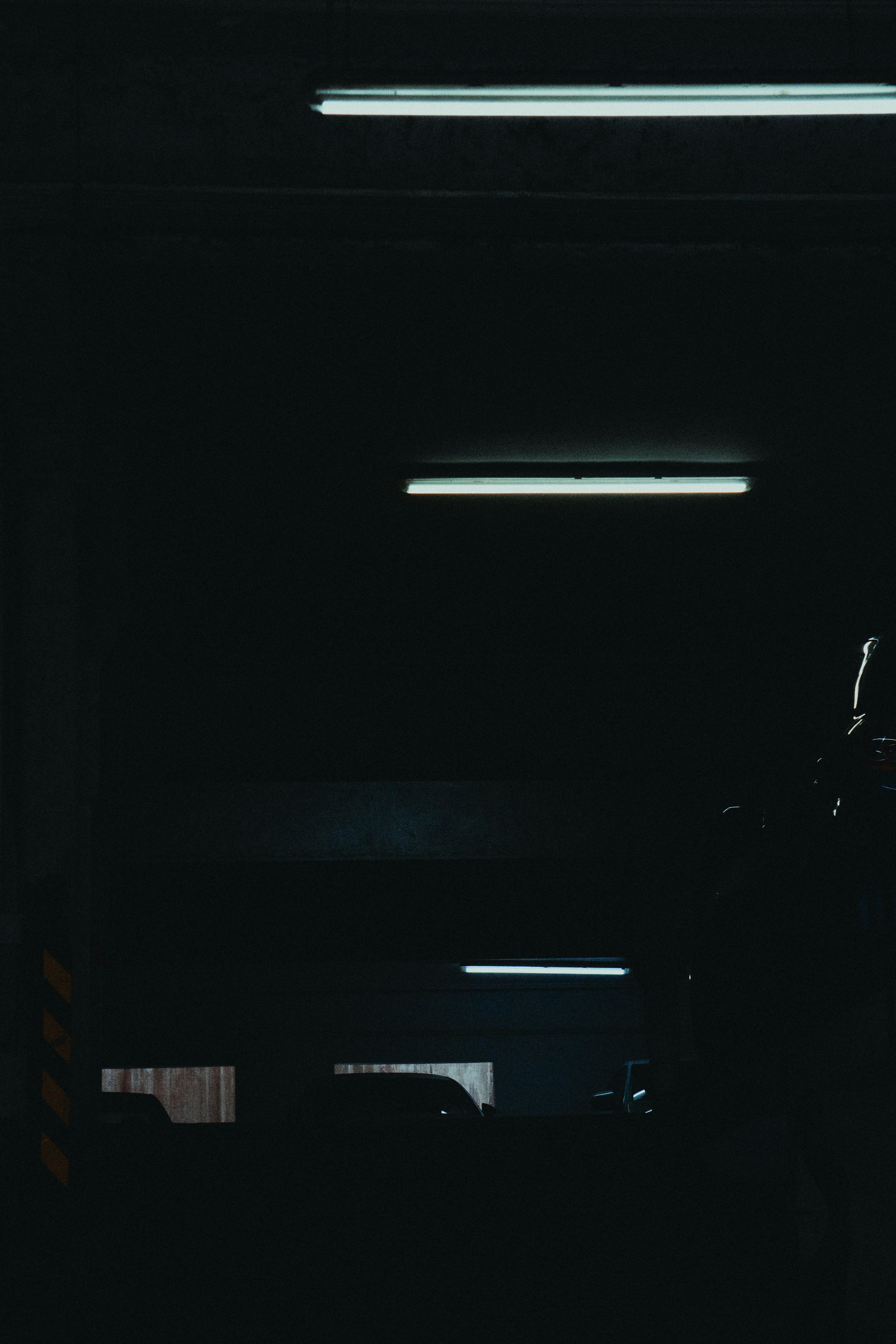 a person standing in a dark room with a cell phone