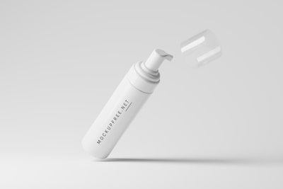 A white pump dispenser bottle with a removable cap, marked with the text 'MOCKUPFREE.NET', is floating against a light gray background. The cap is slightly above the bottle, giving an impression of motion or levitation.