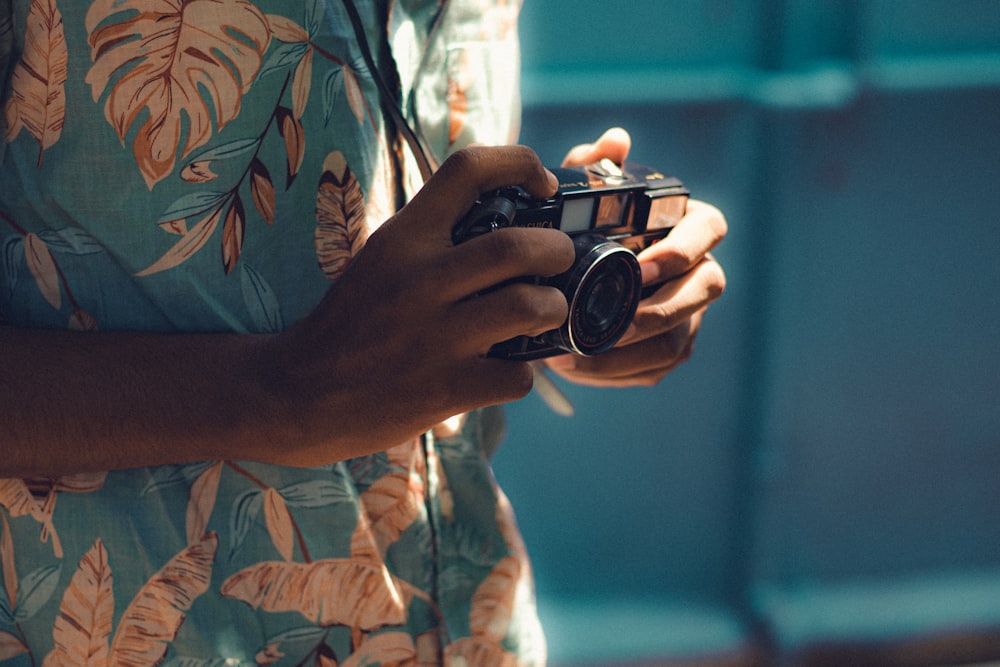 a person holding a camera in their hands