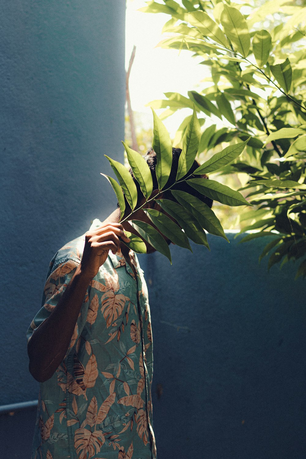 a man holding a plant up to his face