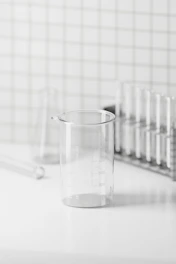Close-up of high-quality laboratory glassware arranged neatly on a clean white surface.