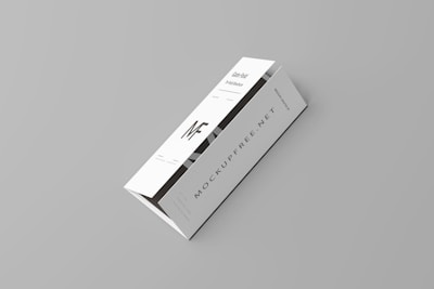 A white tri-fold pamphlet with a minimalist design placed on a light gray background. The pamphlet features bold, black typography with the letters 'MF' prominently displayed. The text 'MOCKUPFREE.NET' is visible, along with some smaller text details. The pamphlet appears sleek and professional.