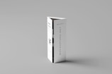 A folded paper brochure with a minimalist design is placed upright against a neutral background. The brochure has text elements, including a bold 'MF' logo and vertical text 'MOCKUPFREE.NET.'