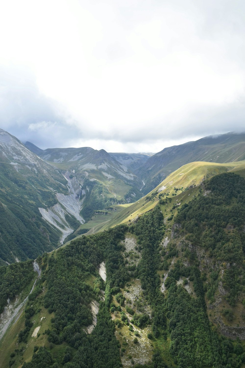 a view of a valley with mountains in the background