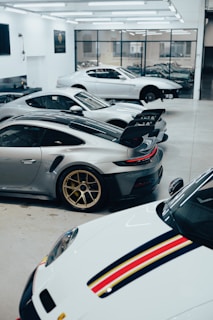 a bunch of cars that are parked in a garage