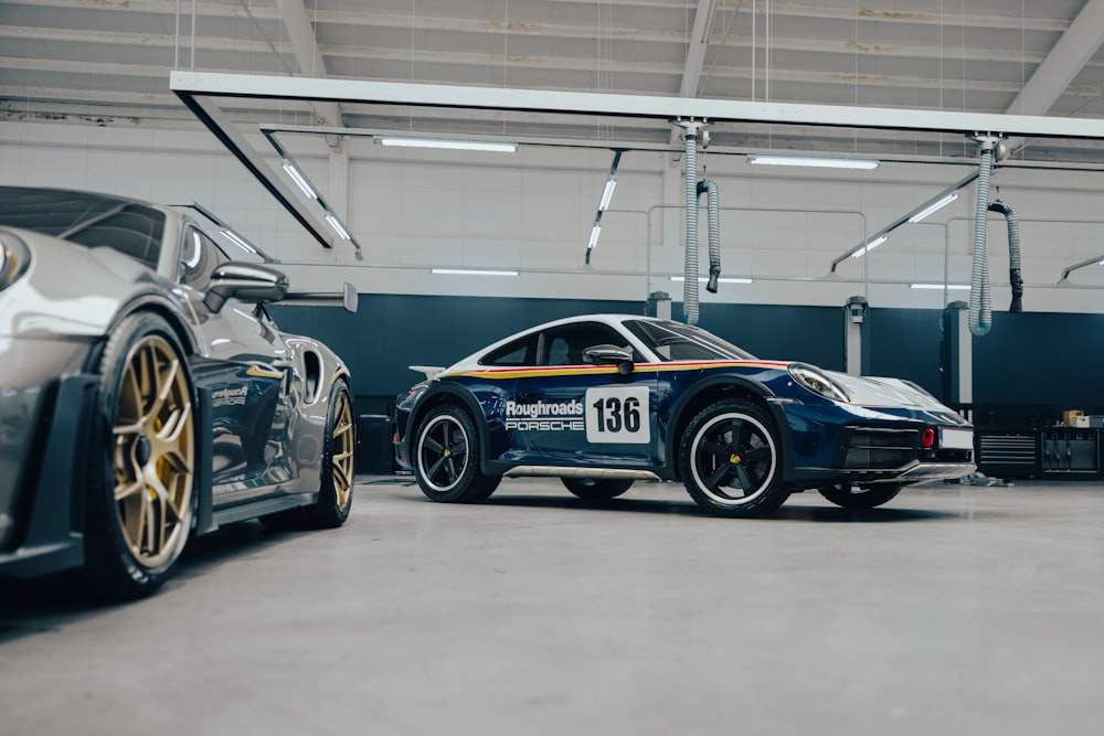 two porsche sports cars parked in a garage