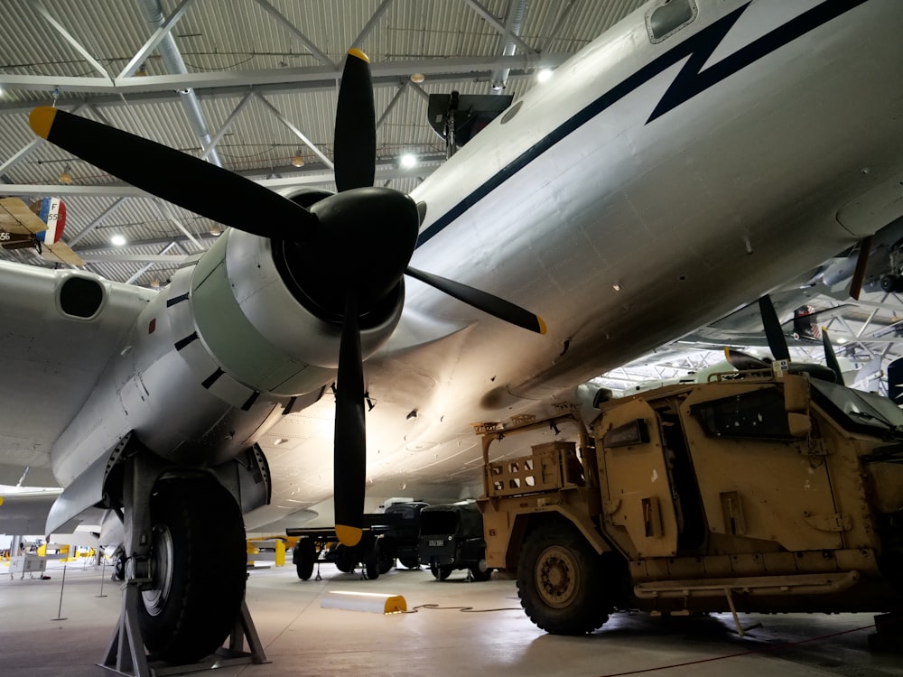 a large propeller plane sitting inside of a hangar