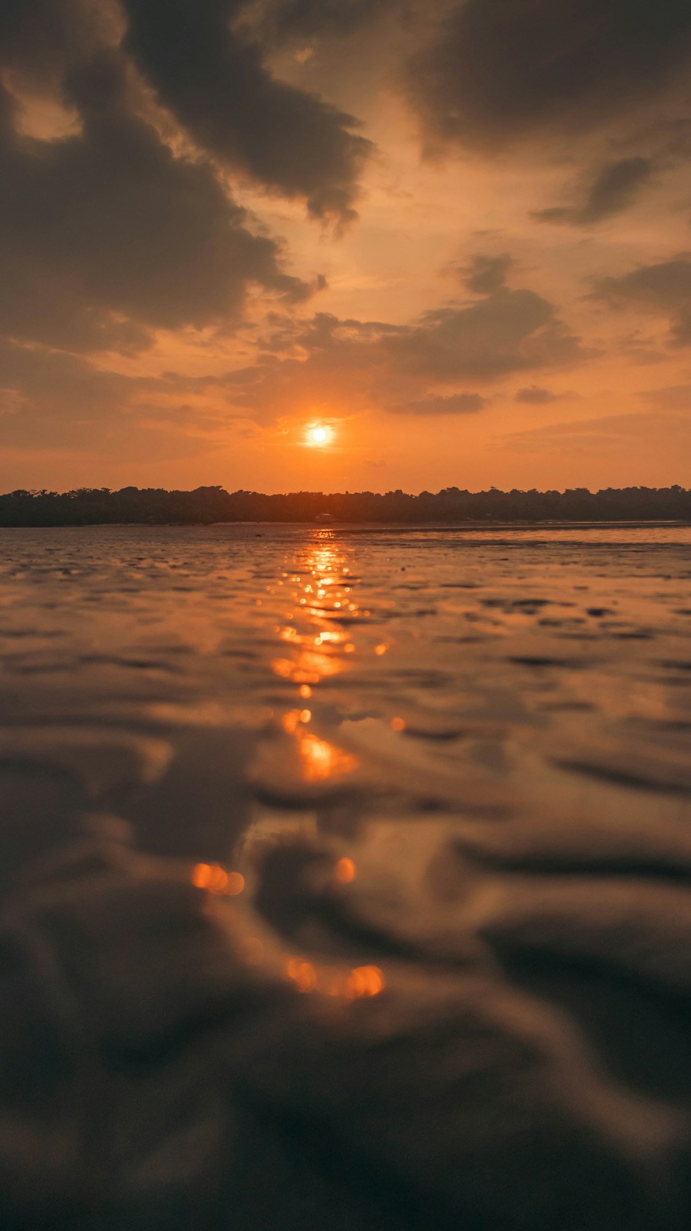 the sun is setting over a body of water