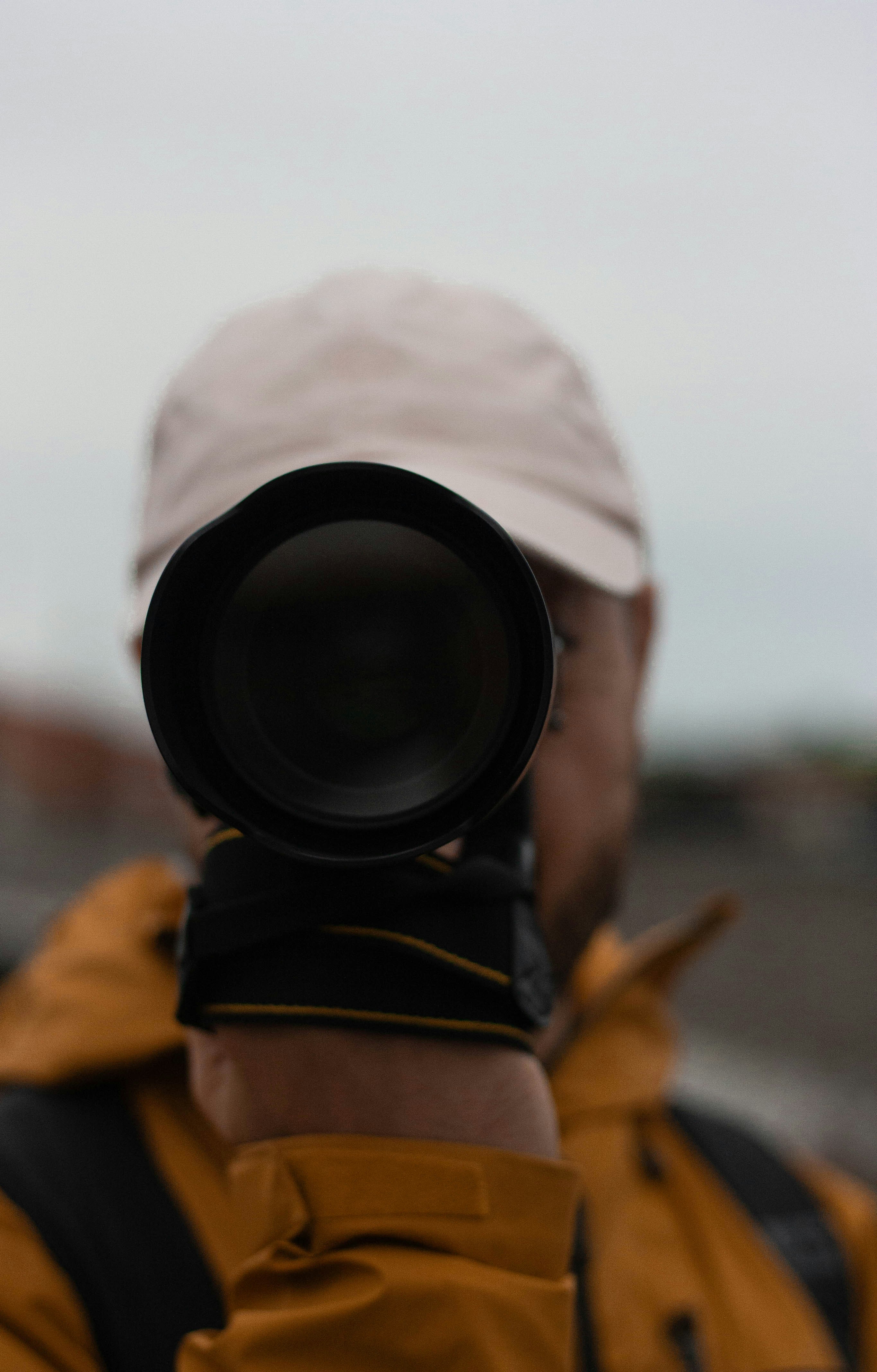 a man wearing a hat and holding a camera
