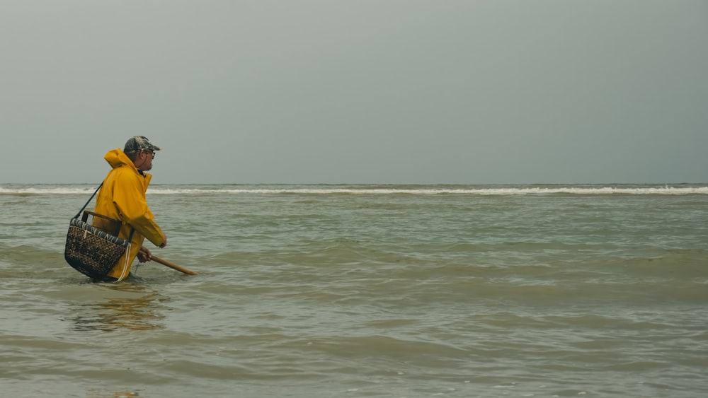 a man in a yellow jacket is in the water