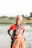 a woman standing in the water with her hands on her hips