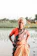 a woman standing in the water with her hands on her hips