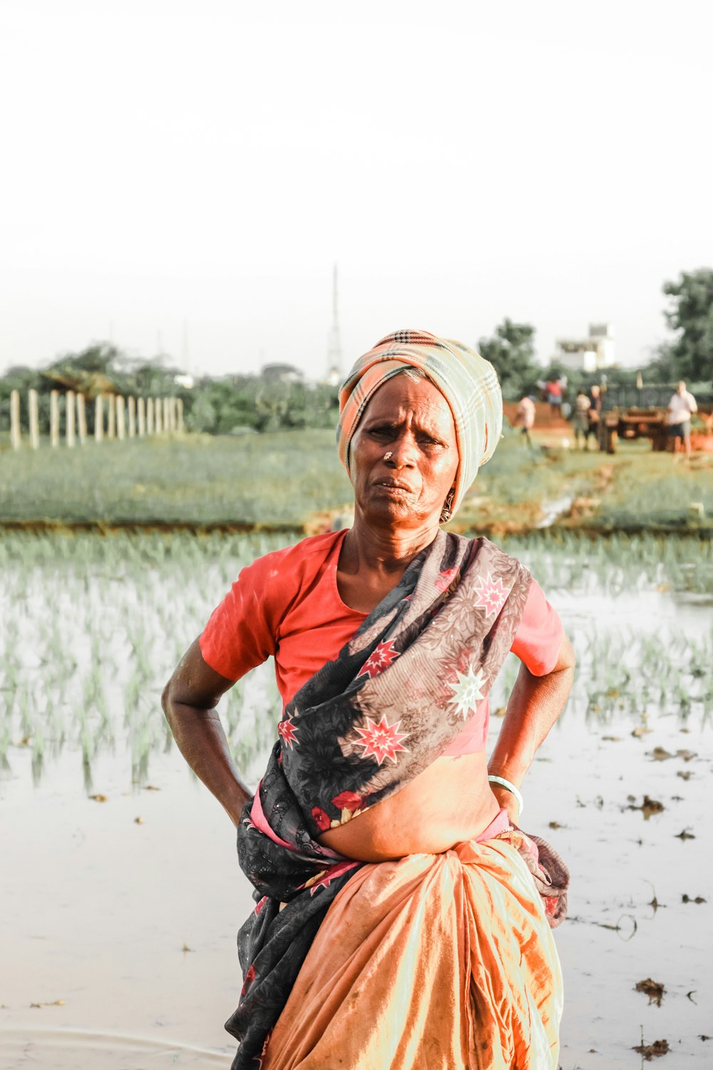 a woman standing in the water with her hands on her hips