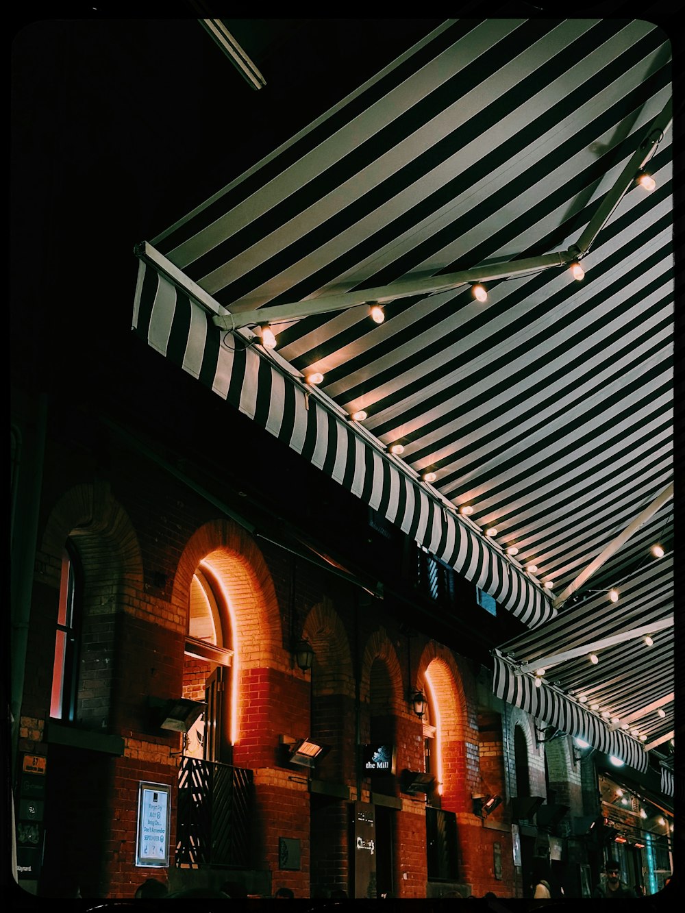 the inside of a building with a striped awning