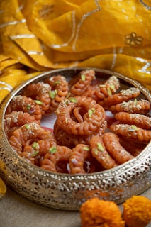 a metal bowl filled with food on top of a table