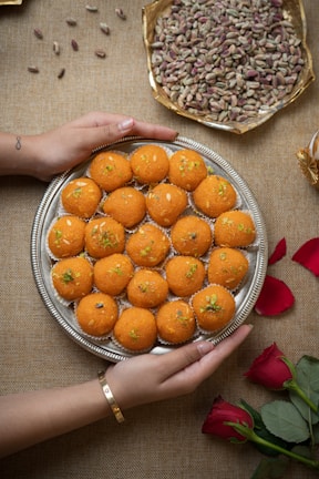 A beautifully arranged tray of maamoul filled with dates and nuts, showcasing intricate patterns.