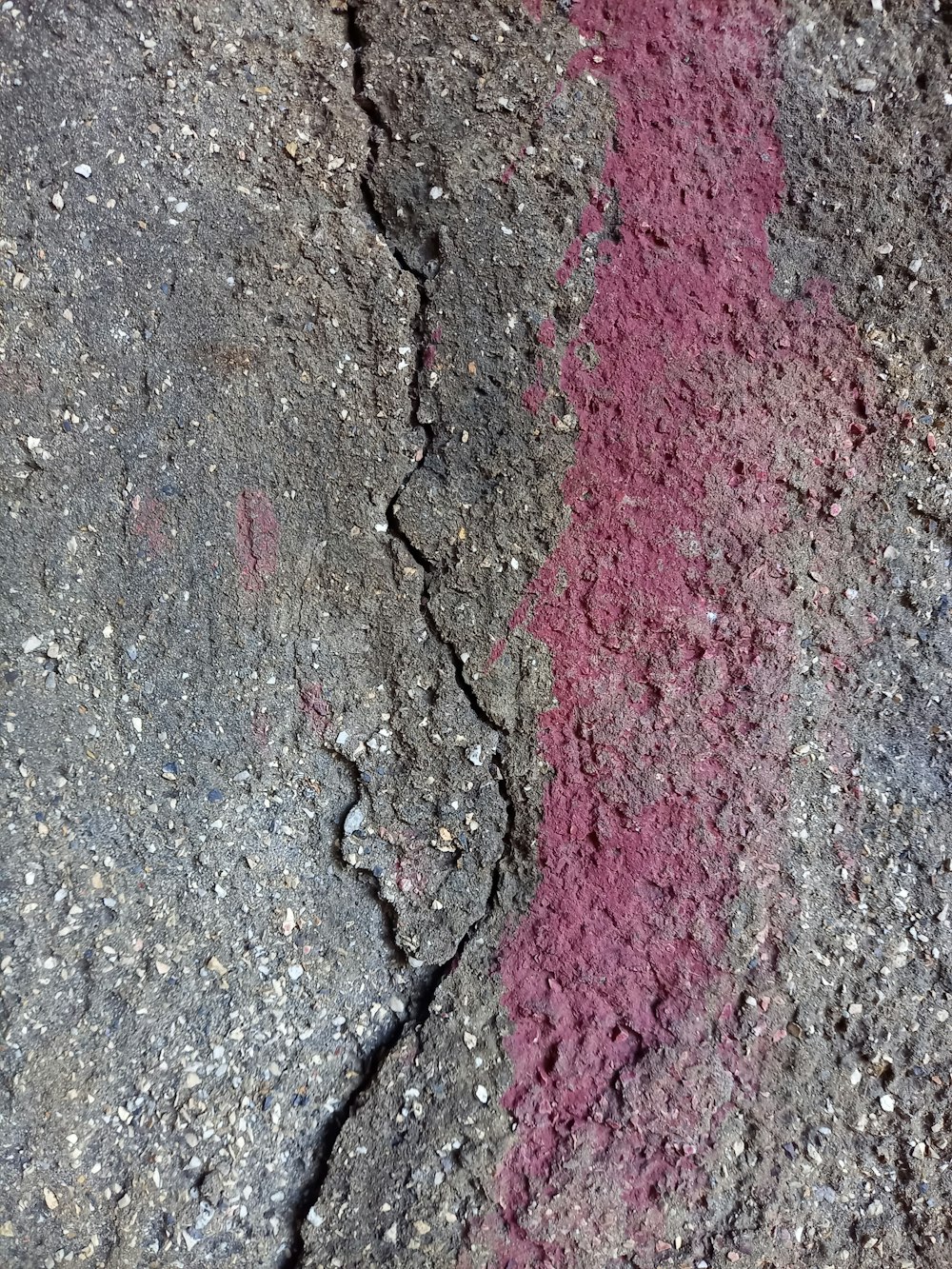 a close up of a red line painted on a rock