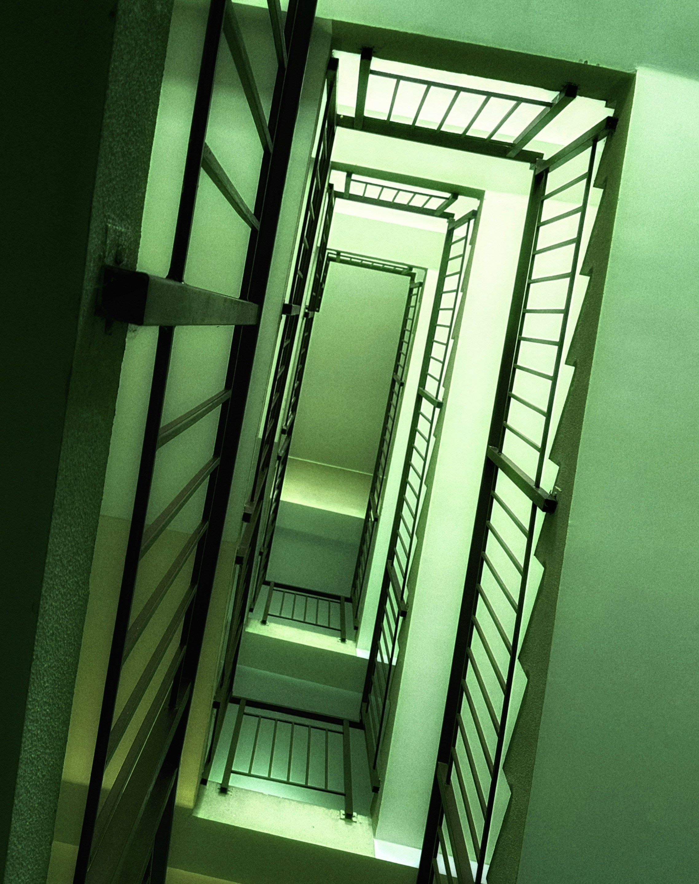 A long narrow hallway with a light coming through it photo Free