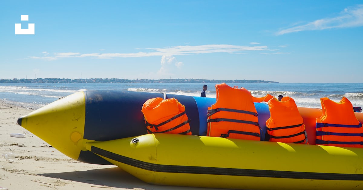 An inflatable raft on the beach with life vests on photo – Free Mui ne ...