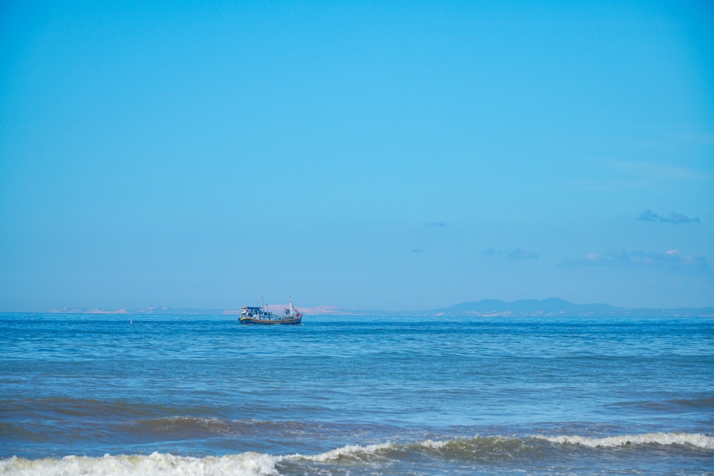 a boat floating on top of a large body of water