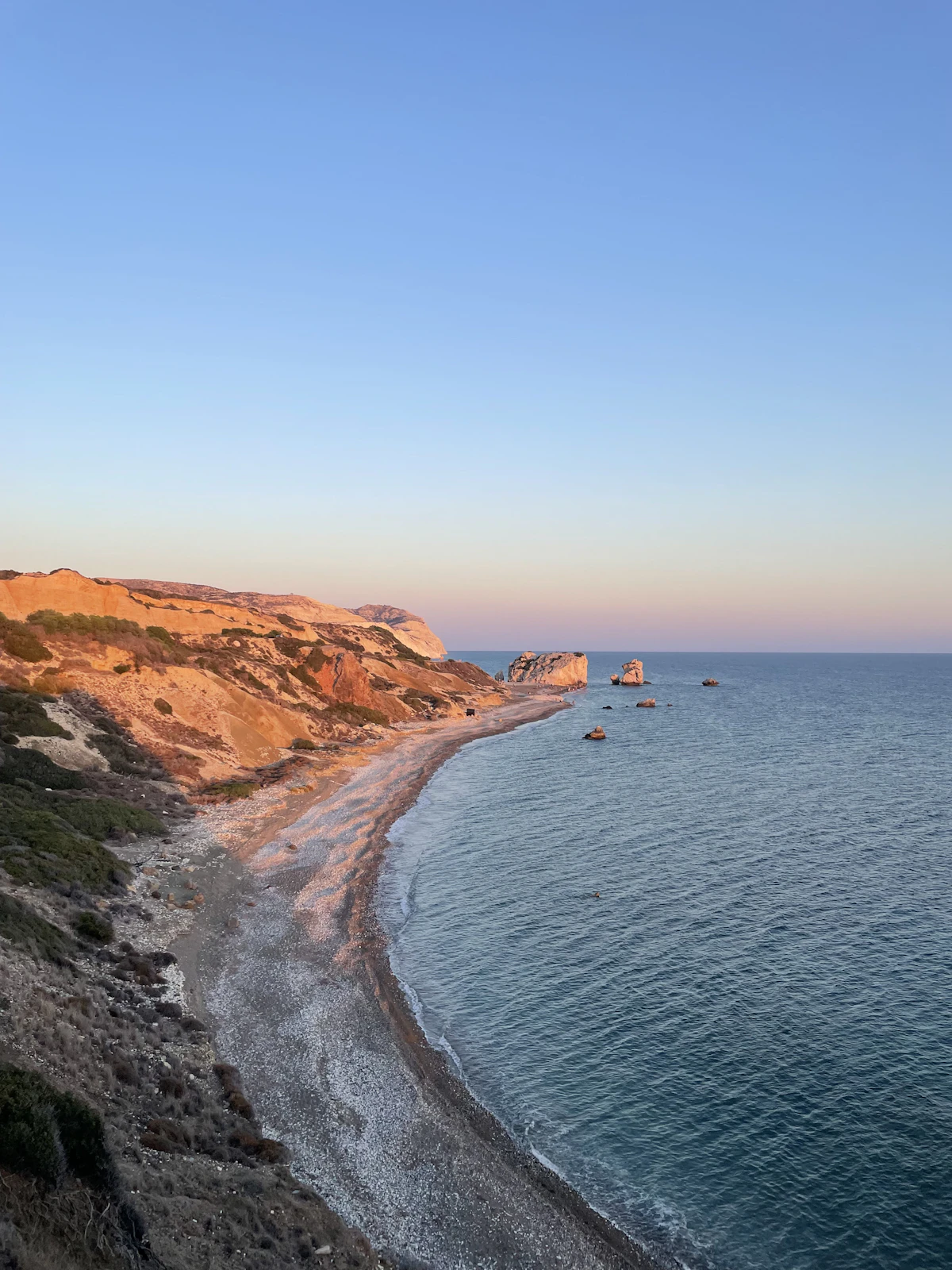 Rocky cliff coastline overlooking turquoise Mediterranean water, illustrative of the Cape Greco coast near Konnos Bay, Cyprus
