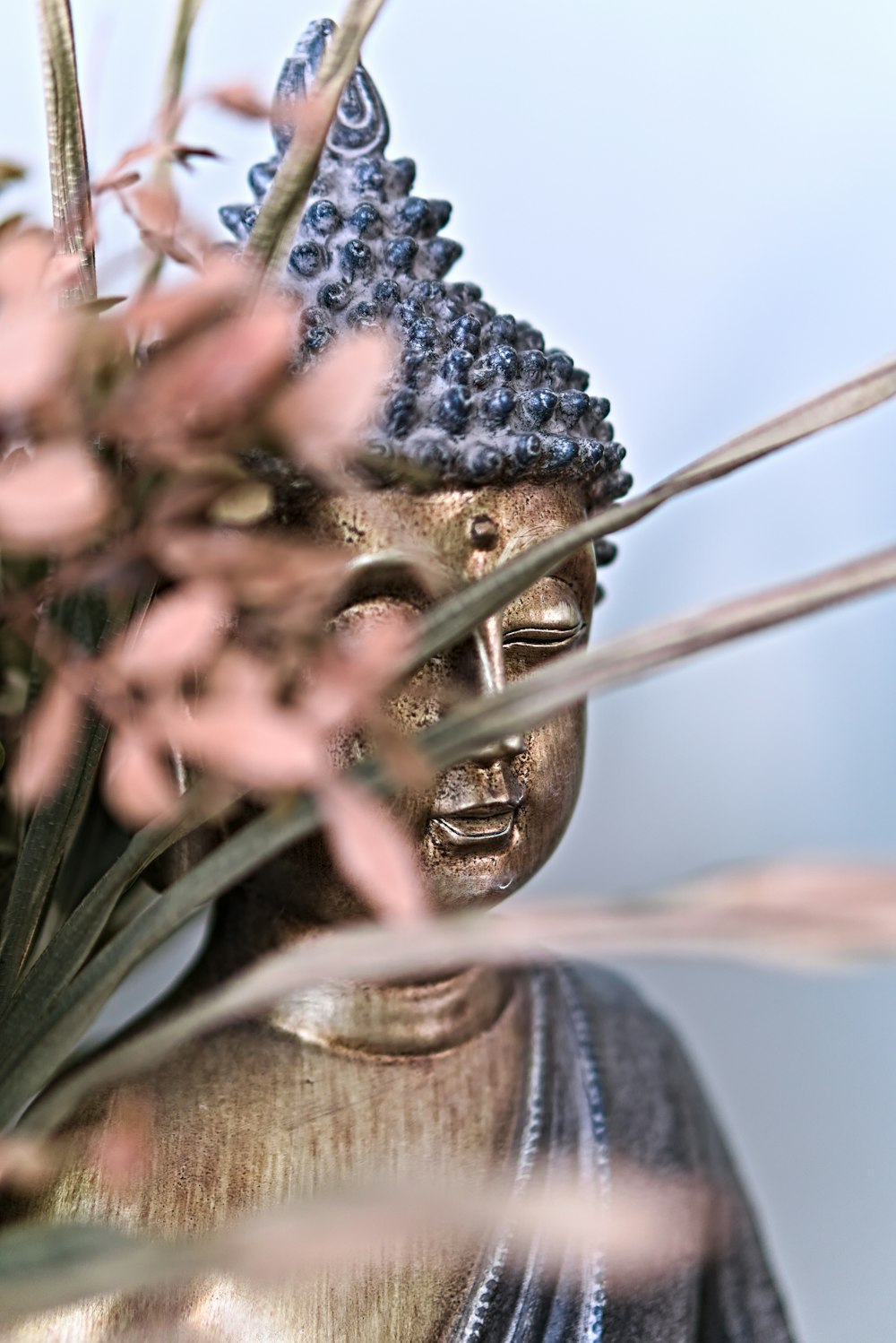 a statue of a person with a flower in their hand