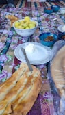 An overhead shot of assorted breads and chutneys on a table.