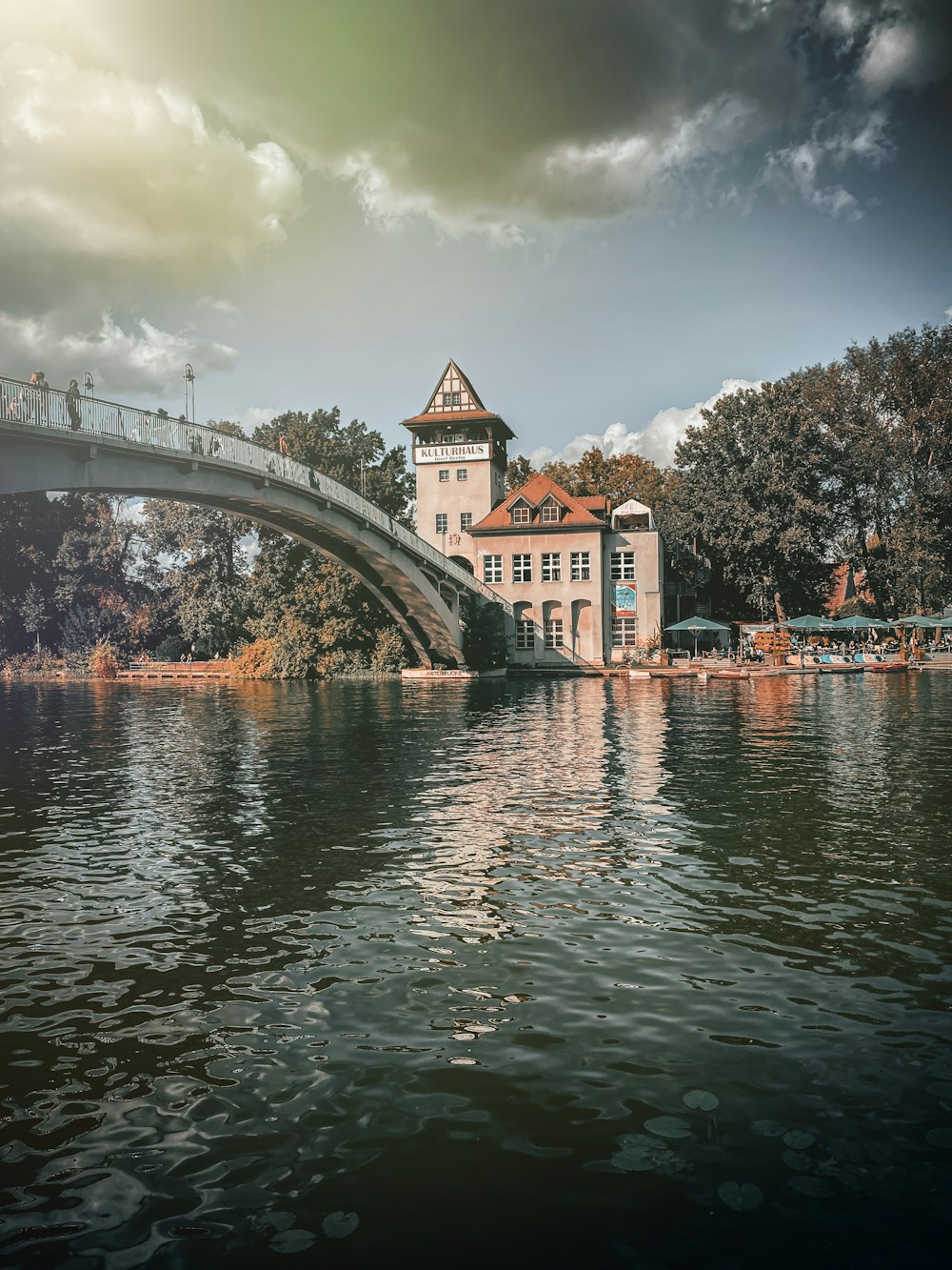 a bridge over a body of water with a building in the background