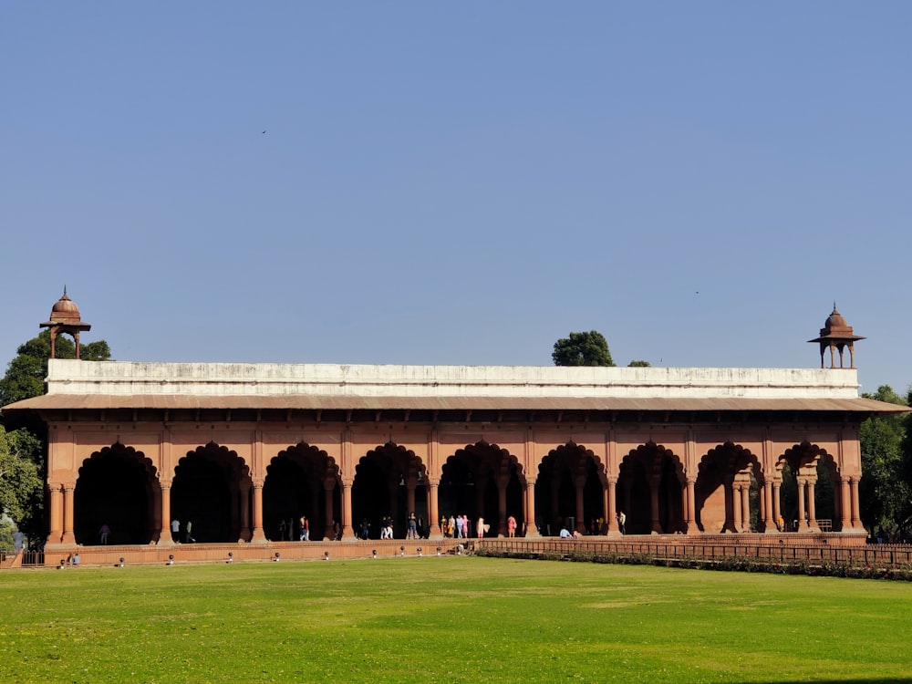 a large building with a green lawn in front of it