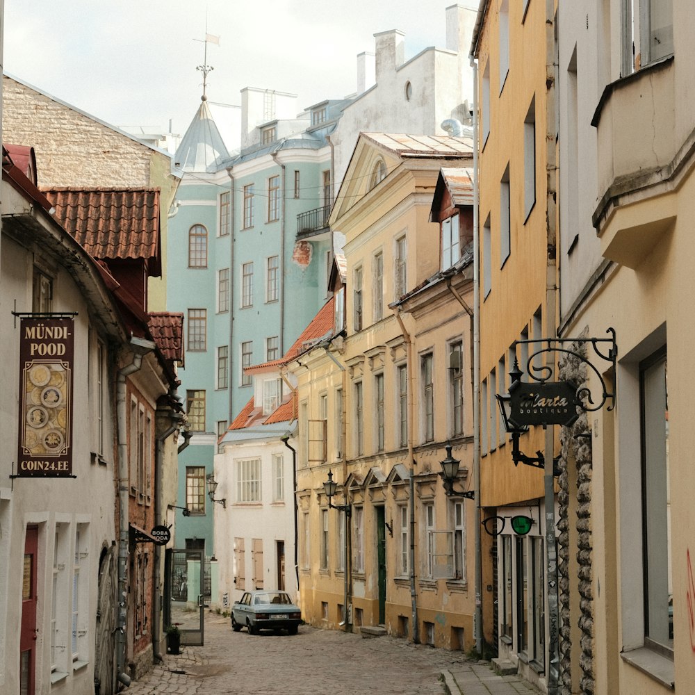 a car is parked on the side of a narrow street