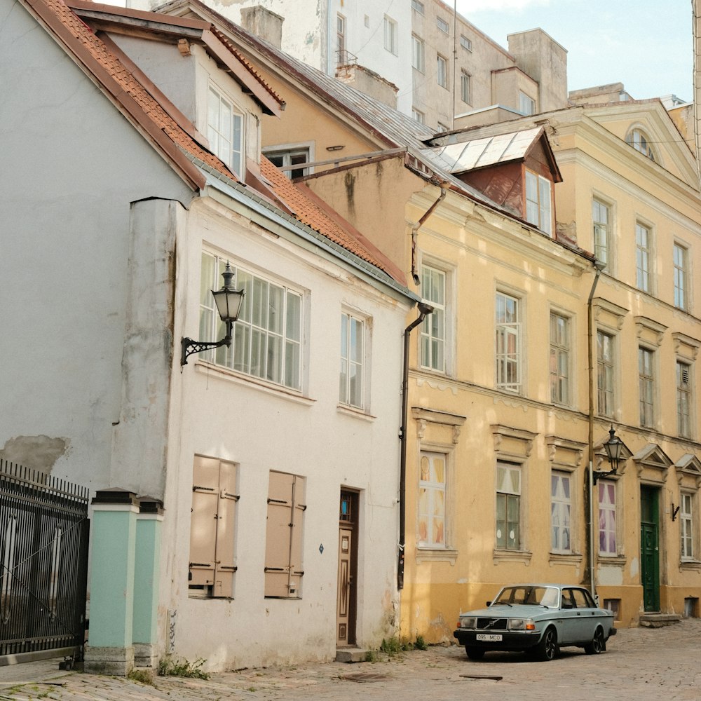 a car parked in front of a row of buildings