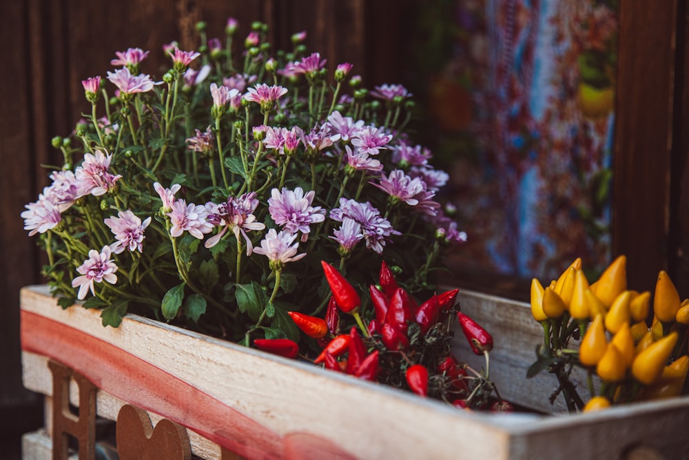 a wooden box filled with lots of flowers