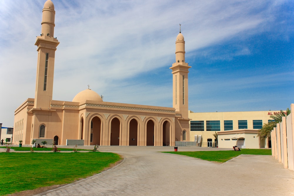 a large beige building with two tall towers