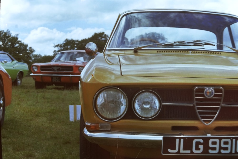 a group of cars parked next to each other on a field