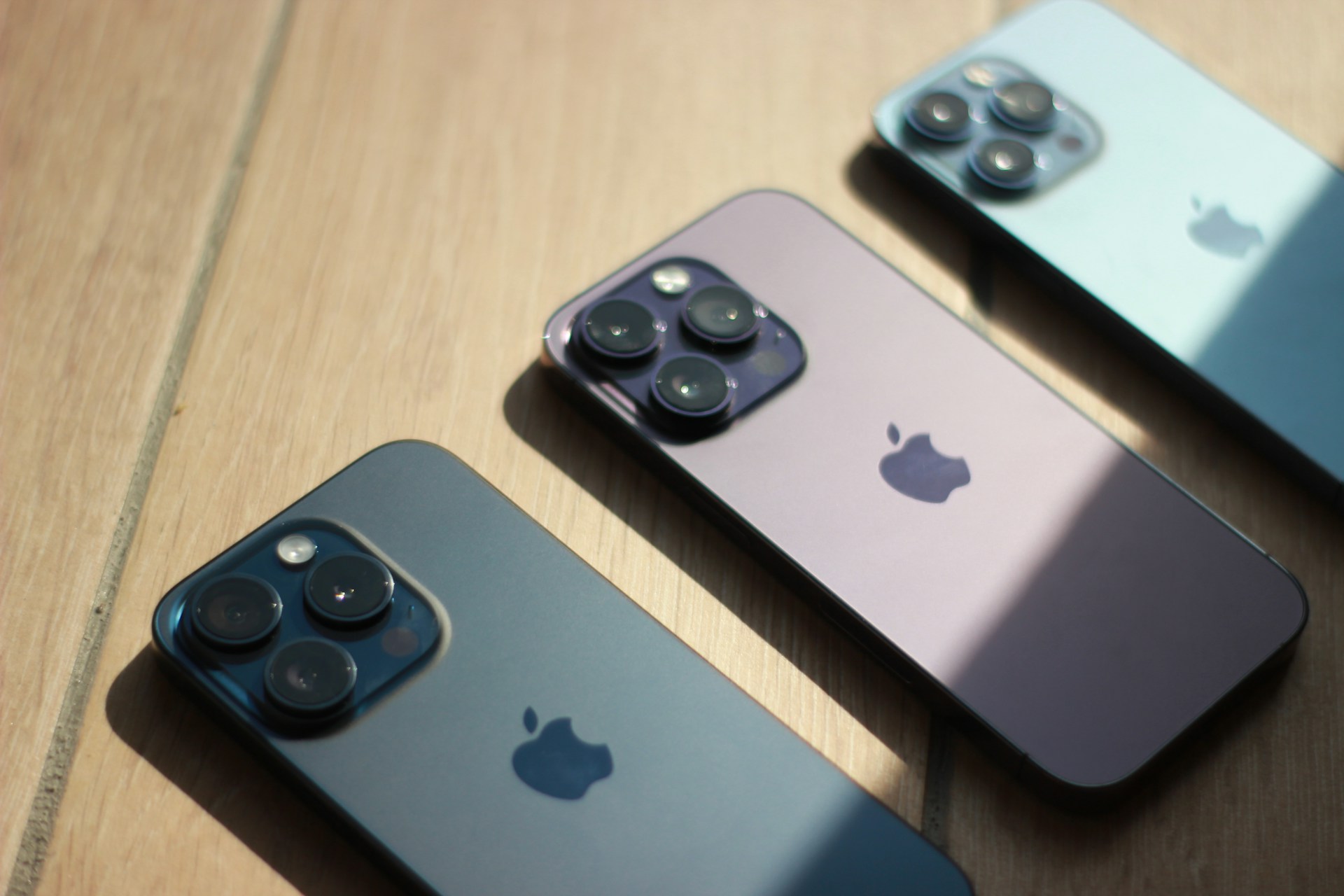 a couple of cell phones sitting on top of a wooden table