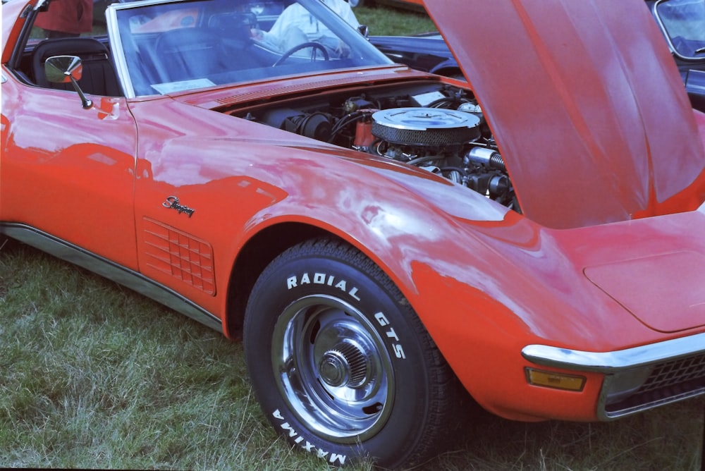 a red sports car with its hood open