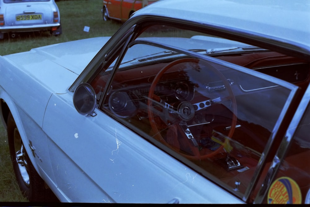 a white car with a red steering wheel