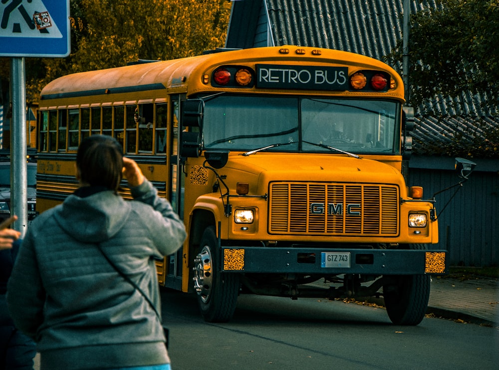 a yellow school bus parked at a bus stop