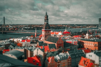 an aerial view of a city with a bridge in the background