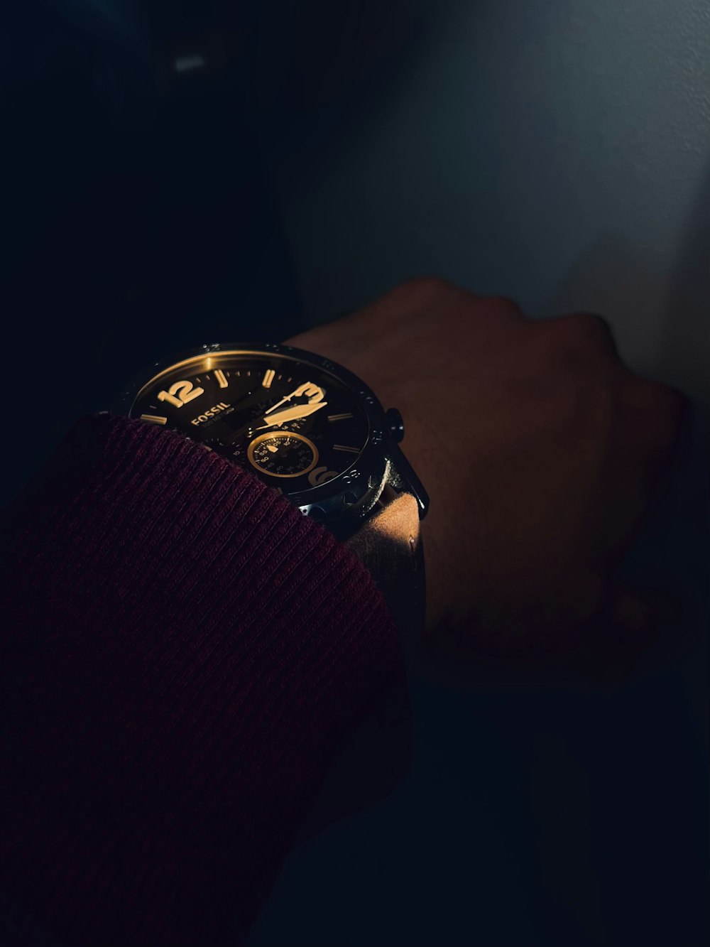 a person wearing a watch in the dark