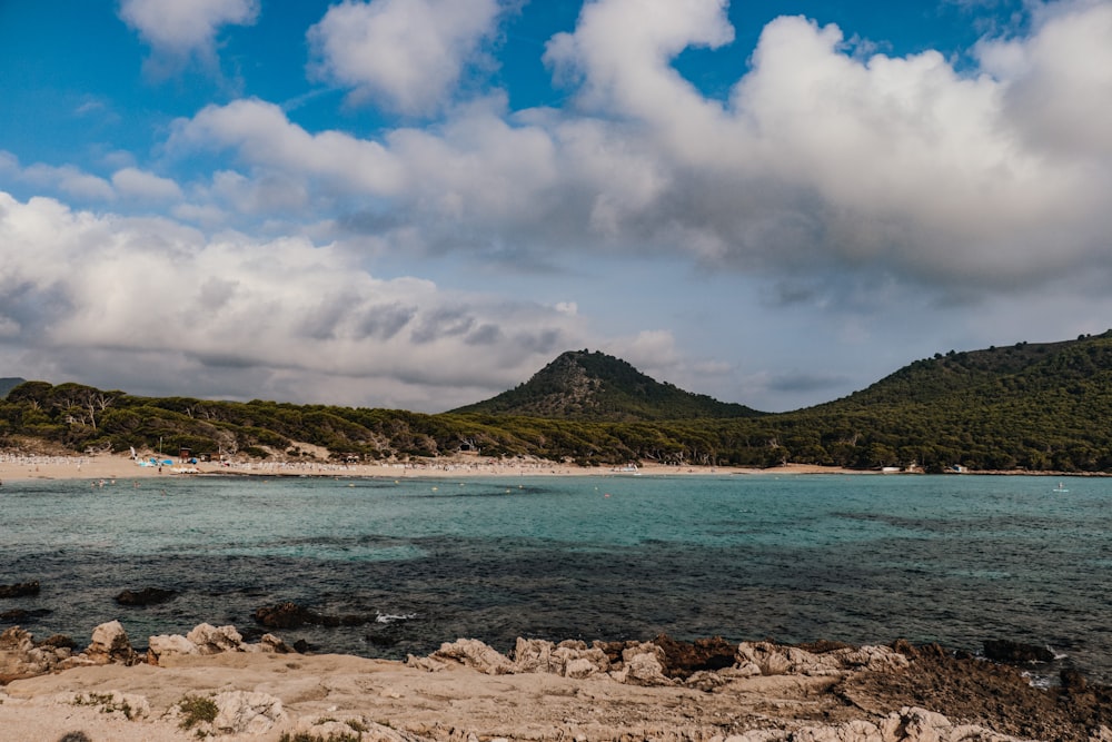 a body of water with a mountain in the background