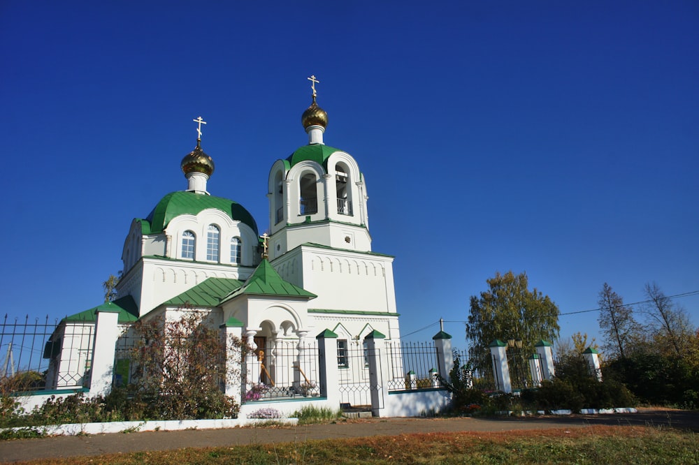 a large white and green church with two towers