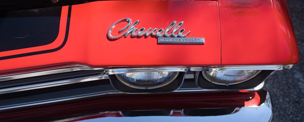 a close up of a red car with chrome lettering