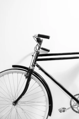 Tools and a bike frame on a white background, highlighting simplicity and order.