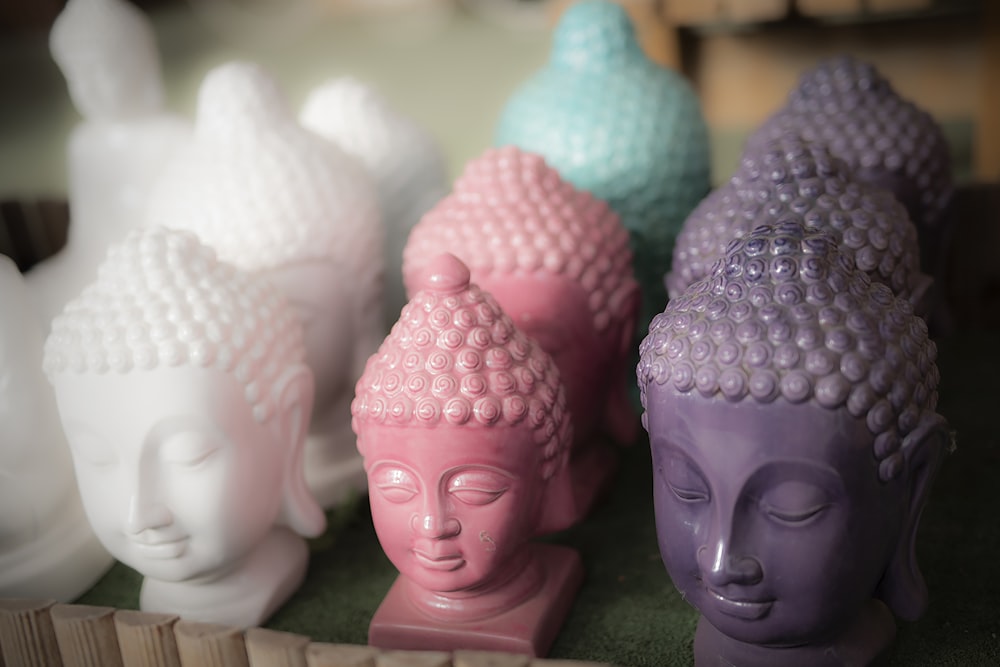 a group of buddha statues sitting on top of a table
