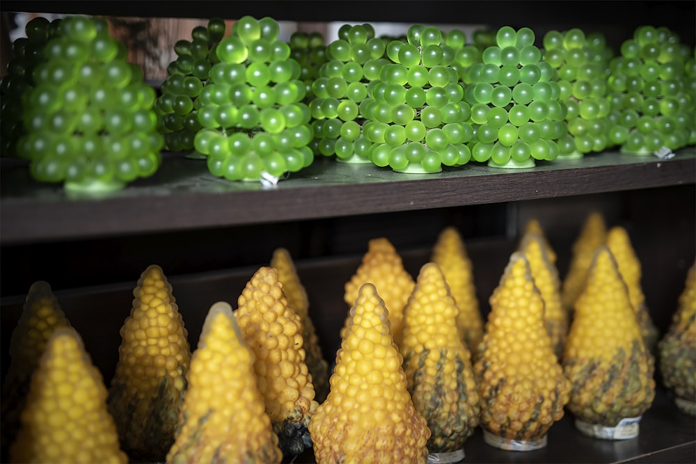 a shelf filled with lots of green and yellow fruit