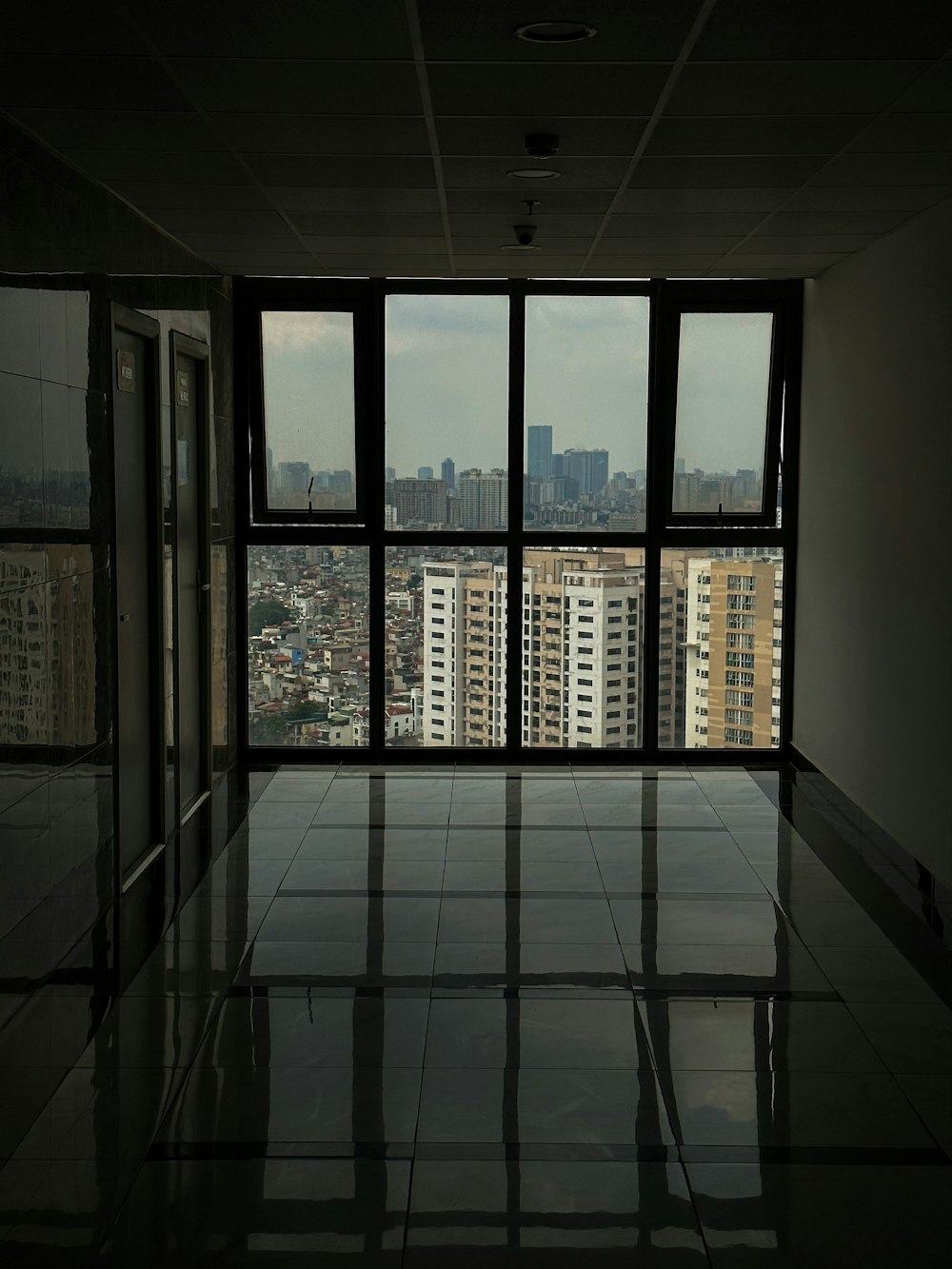 an empty room with a view of a city