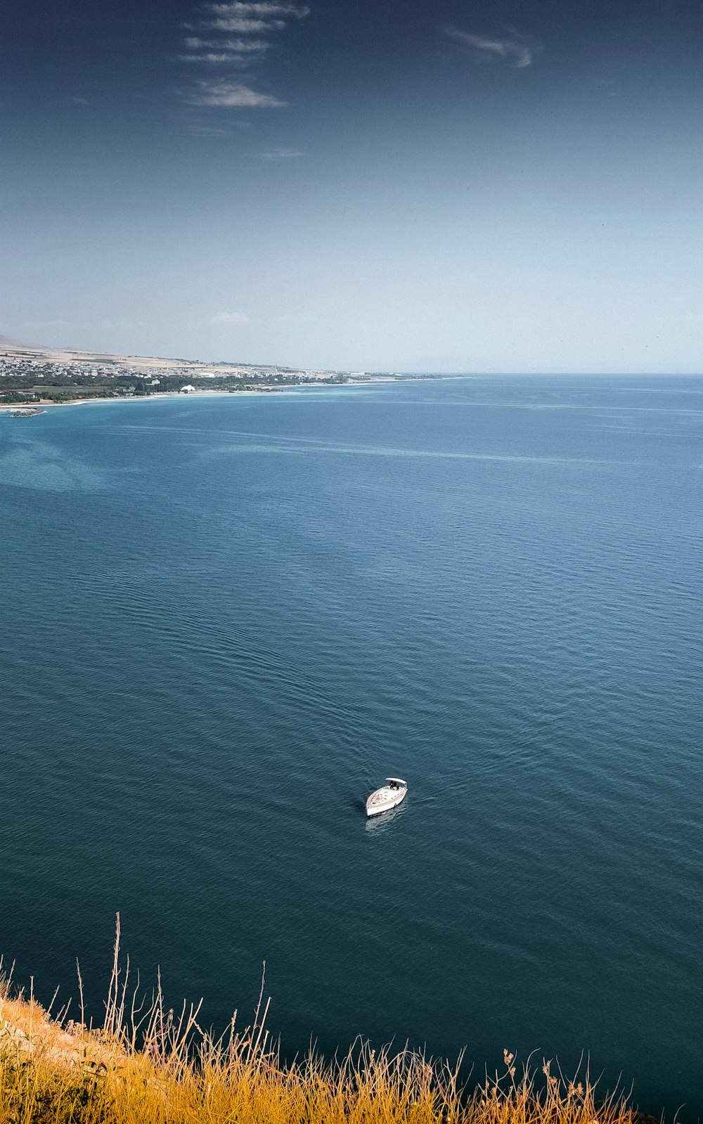 a boat floating in the middle of a large body of water