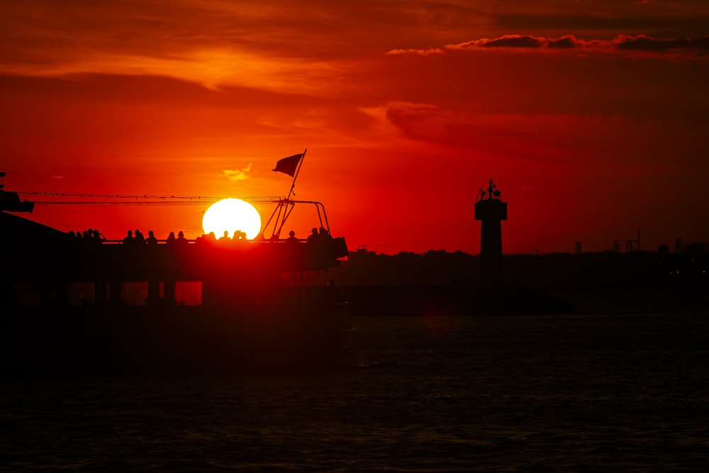 the sun is setting over a body of water