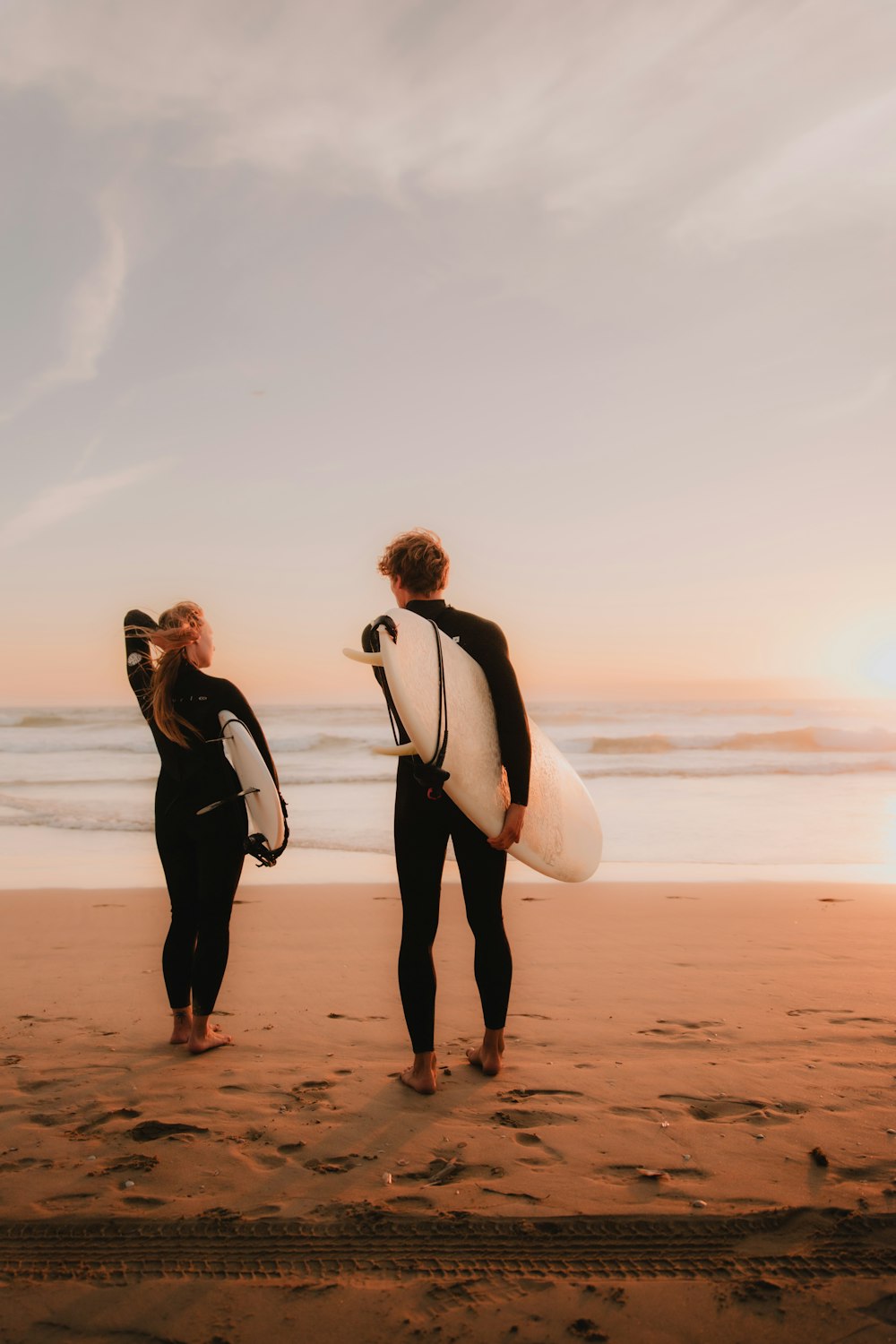 a couple of people that are standing in the sand